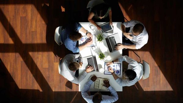 Birds eye view of business people sitting around a table having a meeting