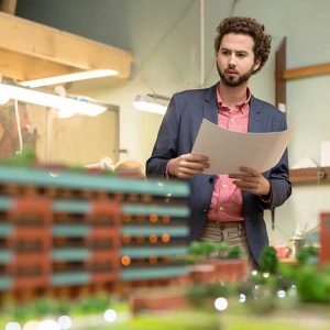 Architect viewing a to scale building model