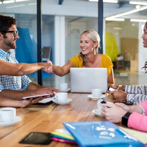 Sales woman making salespitch to a business around a meeting table