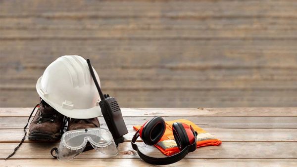 Variety of construction site safety equipment sitting on a bench