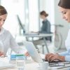 Women working individually in white office